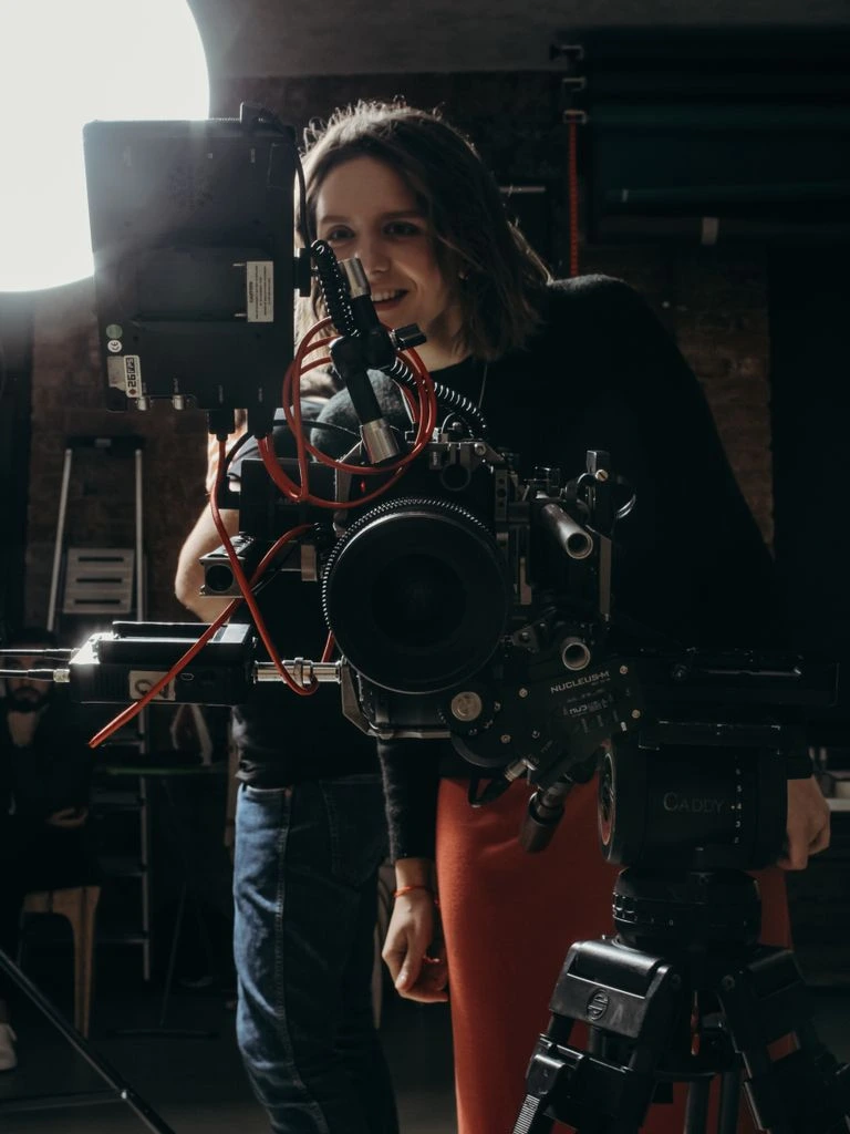A filmmaker watches her film projected in a small independent cinema.