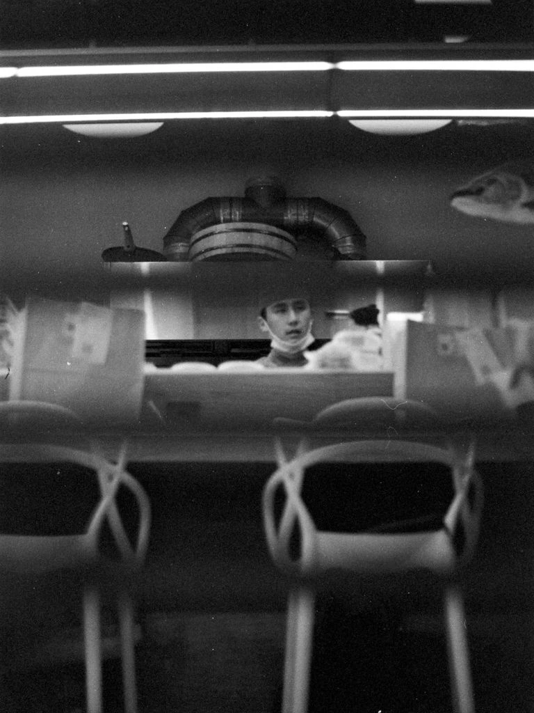 A diner worker rests alone before the morning shift begins.