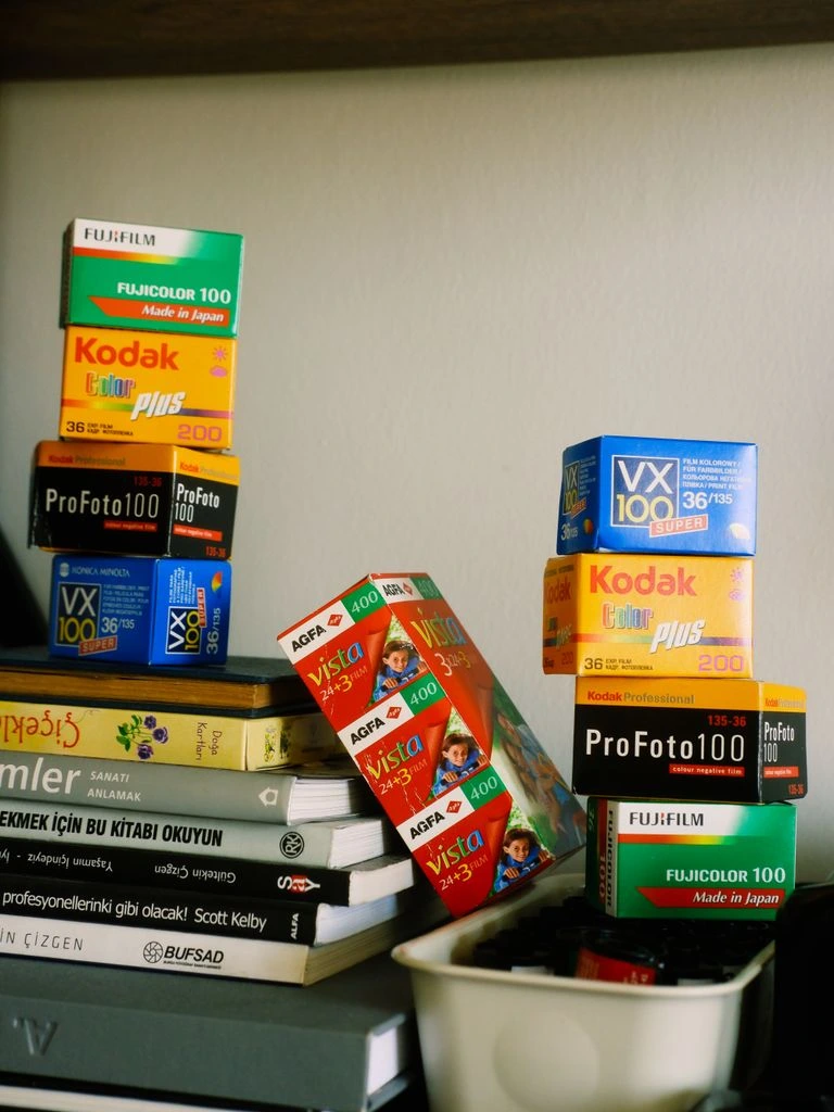 A desk with film magazines, espresso, and reading glasses under a warm lamp.